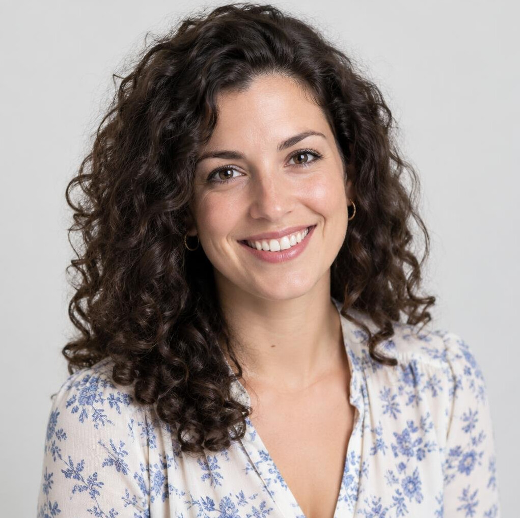Studio portrait of a smiling young woman with curly hair