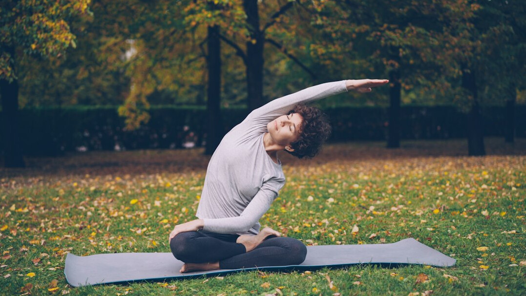 woman doing yoga in park
